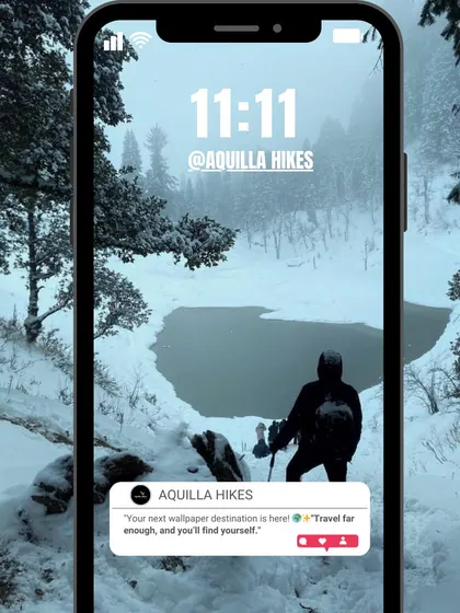 Your 11:11 wish as a wallpaper: a trekker by a frozen lake in the middle of a snowy forest.