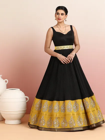The full, standing view of the black and gold gown, a statement piece for any evening soirée.
