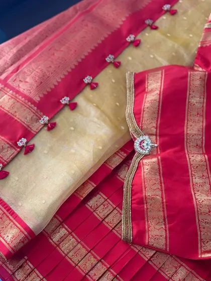 Detail of the sleeve pendant, showcasing the intricate stone and zardosi work.