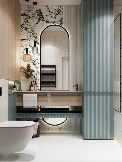 This bathroom design combines natural wood-look laminate with striking black and white marble. The pastel blue fluted storage unit adds a soft pop of color, while the arched, black-framed mirror creates a sophisticated focal point.