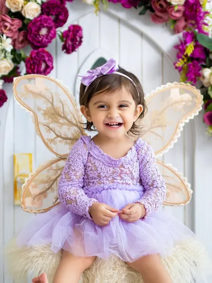 A sweet little fairy with the biggest, happiest smile. Our fairy-themed shoots include beautiful dresses, wings, and a magical floral backdrop.
