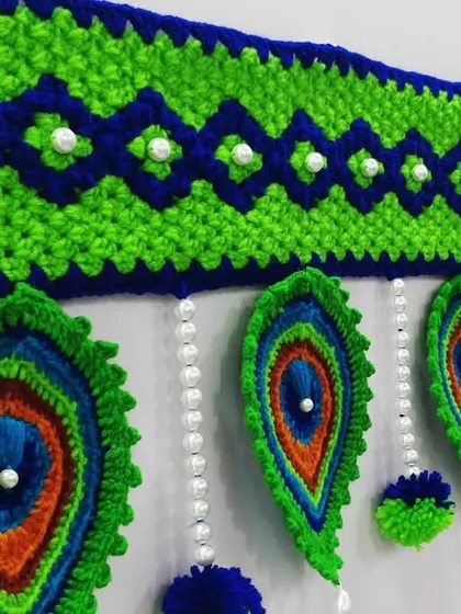 An angled view of the Mor Pankh toran hanging, which shows how the feathers drape beautifully.