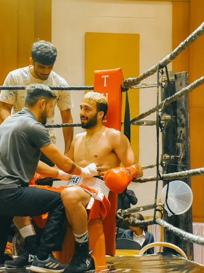 A moment of rest and strategy between rounds. The corner team plays a huge role in a boxer's performance.