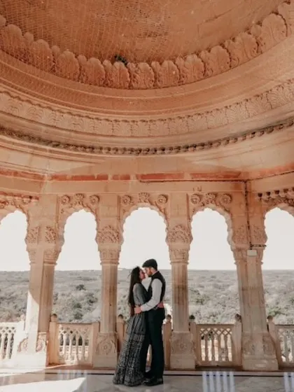 An architectural marvel serves as the backdrop for this beautiful pre-wedding photo. I help plan these shoots to create timeless memories.