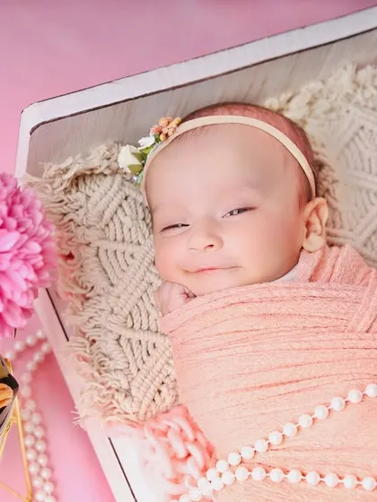 A precious, sleepy smile from the baby in the peach and pink setup. These are the magical moments I always hope to capture.
