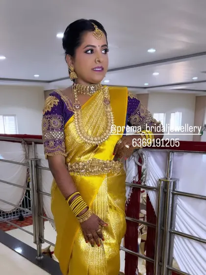 A three-quarter view of the bride, highlighting the vaddanam and bangles.