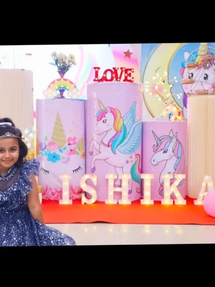 Our unicorn theme is pure magic. This setup for Ishika's birthday features pastel unicorn illustrations on pedestals, a rainbow balloon arch, and light-up letters for an enchanting party.