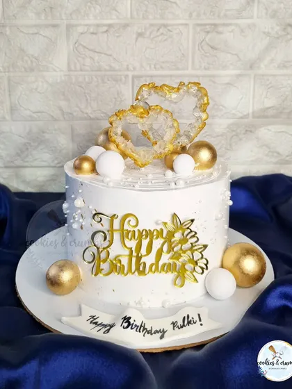 This birthday cake features stunning isomalt crystal hearts, a custom gold topper, and delicate pearl details. It's a design that works beautifully for birthdays, anniversaries, and any celebration of love.