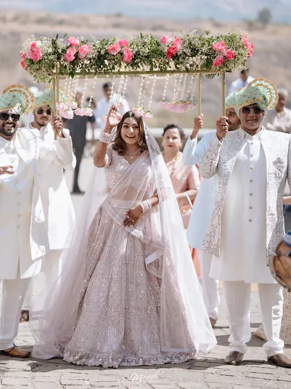The bride's grand entrance under a beautiful 'phoolon ki chadar,' a moment filled with anticipation and emotion as she walks towards her future.