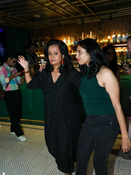 Two women dancing together, one leading the other. Our community is inclusive and encourages everyone to dance in any role they choose.