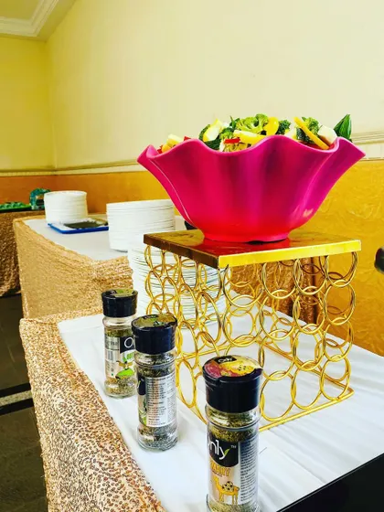 A vibrant salad bowl with various seasonings available for guests. This is part of my commitment to providing fresh, healthy, and customizable food options.