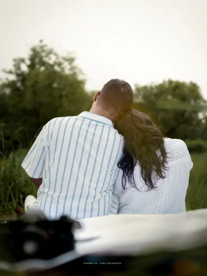 A quiet moment of togetherness, resting against each other in a peaceful field. This shot captures the comfort and intimacy of their bond.
