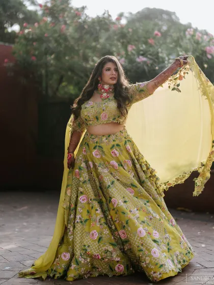 A beautiful twirl shot, showing off her stunning floral lehenga. The makeup is kept fresh to balance the vibrant outfit.