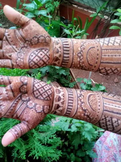 The rich, dark stain of a bridal mehendi, photographed outdoors. The natural light brings out the depth of the color and the complexity of the patterns.