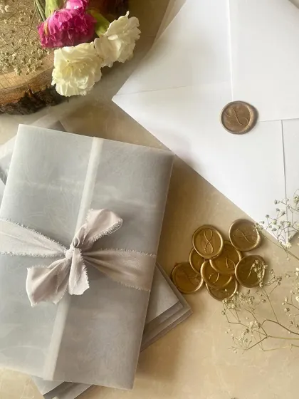 I love curating unique, toned invitation suites. This one features a beautiful grey vellum wrap tied with a soft, hand-dyed silk ribbon and finished with a custom gold wax seal.
