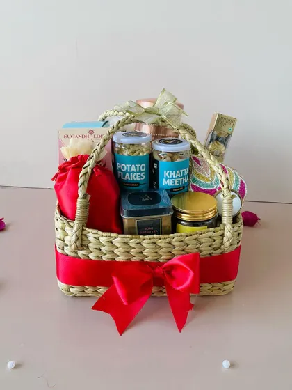 The rich red ribbon beautifully complements the natural texture of the Kauna grass basket, making it a visually appealing gift.