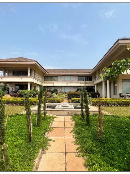 Planned on an open H design, this Tuscan architecture inspired home is set on the edge of Kune Plateau. A 100 foot-long corridor containing a library and gallery connects the residential to the guest wing.