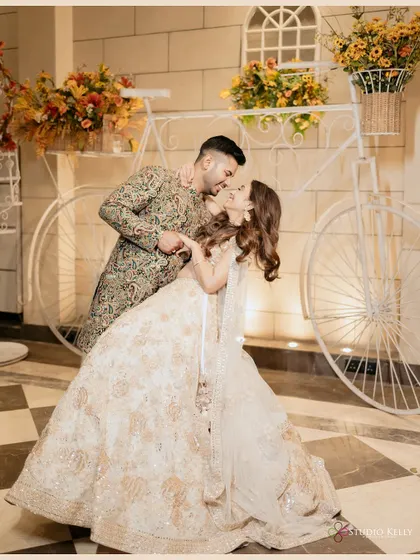 A romantic and playful shot of the couple, with the groom leaning in for a kiss.