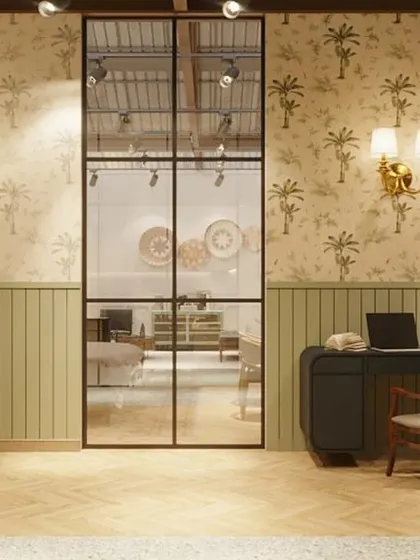 A small home office vignette, framed by industrial-style glass doors. This setup helps customers visualize how Gulmohar Lane's pieces can create a functional and stylish workspace at home.