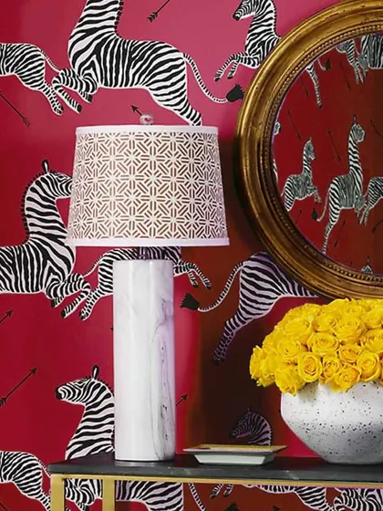 An inspiration image showing a bold red wallpaper with a repeating zebra pattern. This type of design is perfect for making a fearless and stylish statement.
