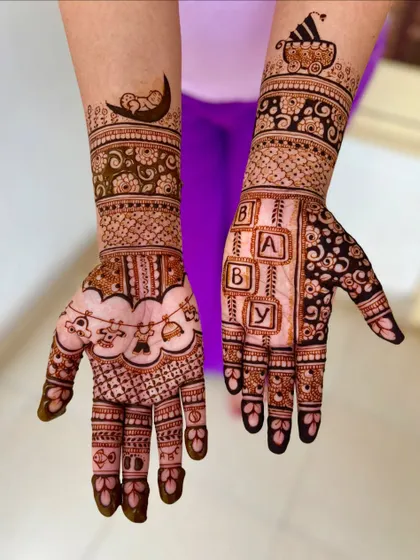 An alternate angle of Akansha's baby shower mehendi, highlighting the different designs on each arm.