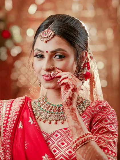A playful and beautiful close-up of the bride adjusting her nose ring, her expression full of charm.
