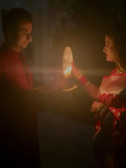 The gentle, candlelit moment of the Karwa Chauth ritual between Dilpreet and Ishvinpal. Their celebration is a beautiful blend of tradition and modern love.