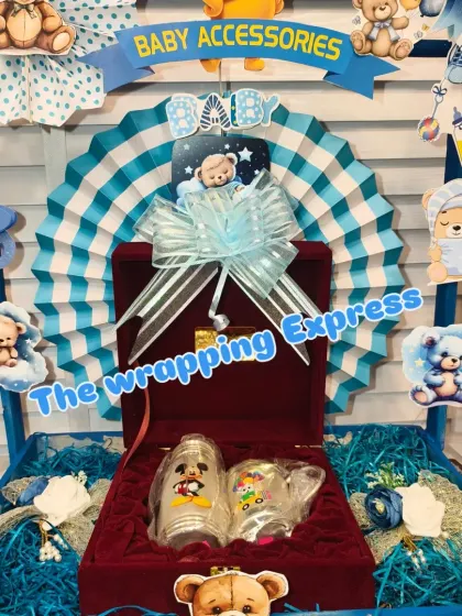 A silver glass and bowl set for the baby, packed in a beautiful red velvet box as part of the 'Big Brother Express' hamper.