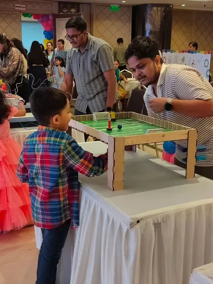 A father and son duo enjoy a game of tabletop football. Many of our activities are designed to encourage parent-child interaction and teamwork.