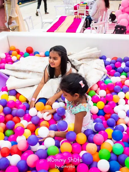 Two young princesses enjoying the vibrant ball pit. It’s a safe and fun activity that adds a playful element to even the most elegant of parties.