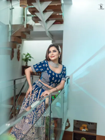 This shot showcases how the lehenga looks in a beautiful indoor setting, with the modern architecture complementing the traditional outfit.