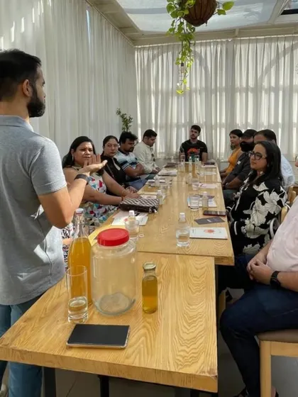 An instructor explains the science of fermentation to an engaged audience. Our workshops are not just about doing, but also about understanding the 'why' behind the process.