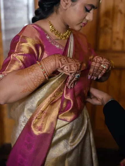 A candid moment of the bride getting ready, a glimpse into the behind-the-scenes of the wedding day.