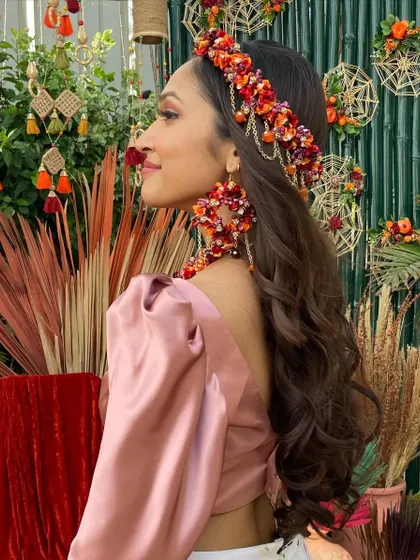 A side view showing off the intricate floral jewelry and the soft, flowing hair.
