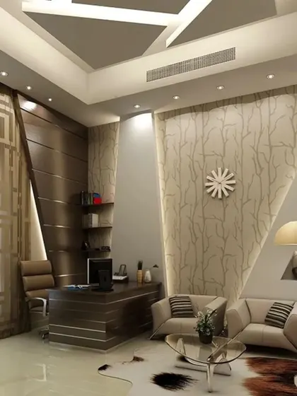 This luxurious home office and lounge area combines rich wood paneling with geometric wall features and integrated lighting. The design creates a sophisticated and professional environment that is also comfortable for meetings or relaxation.