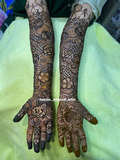 A beautiful design featuring a mix of roses and other flowers, with a lovely border at the top of the arms.
