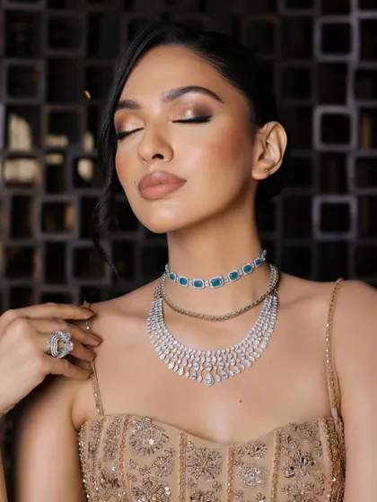 A serene, eyes-closed portrait to appreciate the soft, golden shimmer on the eyelids and the flawless, glowing skin.