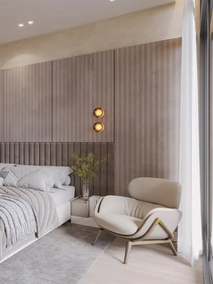 This close-up highlights the layered textures of the headboard and wall panels, along with the soft glow of the wall sconces.