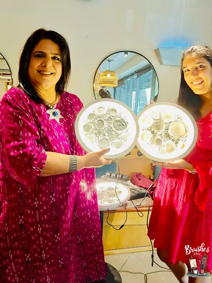 A mother and daughter proudly display their finished moon lamps. A perfect end to a creative and memorable Mother's Day celebration.