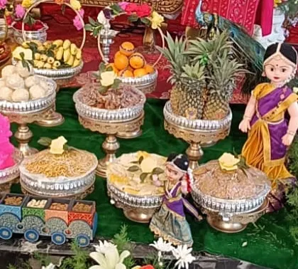 A close-up of various sweet and savory platters, including a fun toy train carrying dry fruits.