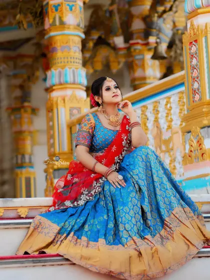 This half saree is a work of art, with its rich fabric and intricate details, available for you to rent.