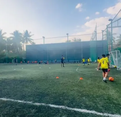 A wide shot of a training session in progress. Our drills are designed to use the entire field, encouraging movement and spatial awareness.