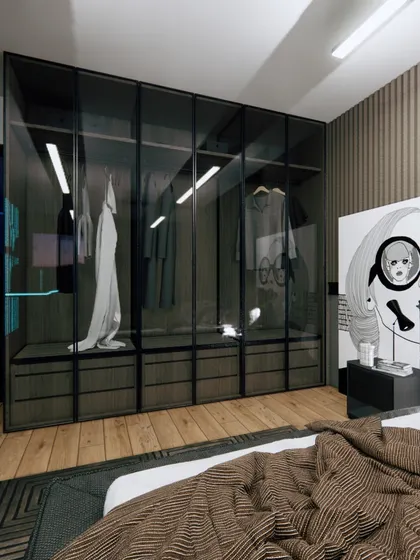 A walk-in wardrobe with smoked glass doors and integrated lighting offers a sleek and modern storage solution for the gaming room.