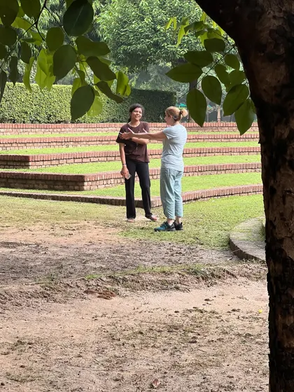 A candid conversation in the beautiful, terraced gardens of the retreat center. These moments of connection and sharing are an integral part of the community experience.