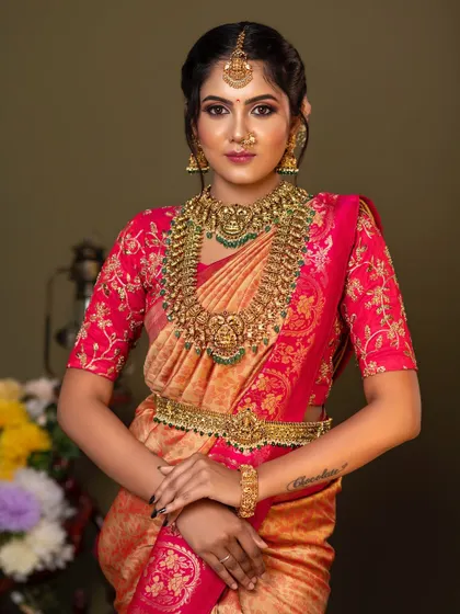 A confident and beautiful pose. The intricate details of the temple jewellery, from the choker to the haram, are clearly visible, showcasing the quality of our rental collection.