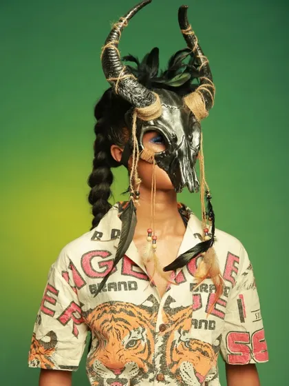 Another angle of the masked look for Diseno.in, highlighting the intricate details of the headpiece and the tiger-print shirt.