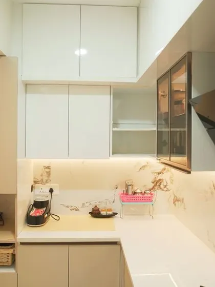 This angle highlights the integrated refrigerator and tall storage units, showcasing our ability to create seamless and highly functional kitchen layouts. The under-cabinet lighting provides excellent task illumination.