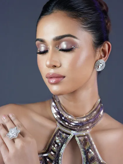 A soft, dreamy shot of the glam look. Even with eyes closed, the makeup is the star, with beautifully blended eyeshadow and radiant skin.