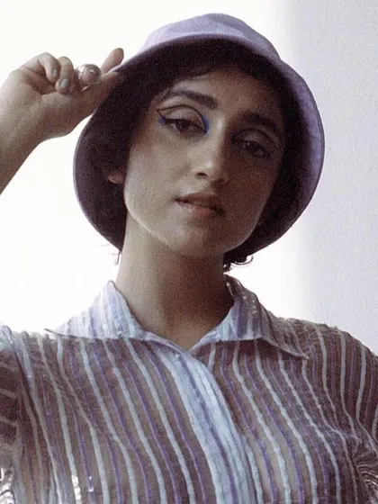 A soft, retro-inspired look for Sanjeeta, featuring a striped shirt and bucket hat. This shows my versatility in creating different moods for a single project.