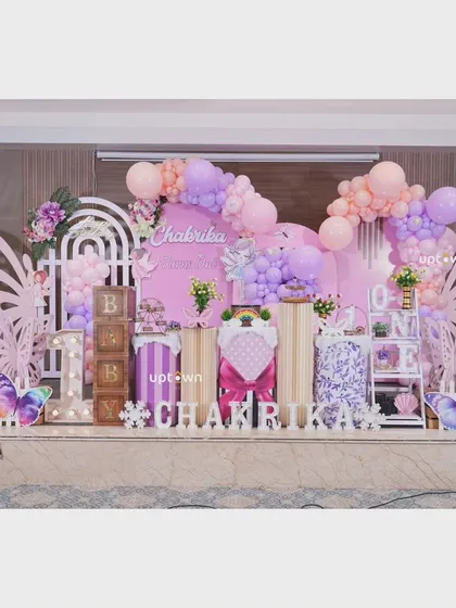 A beautiful butterfly theme for Chakrika's first birthday, with pastel purple and pink decor.